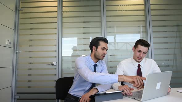 slow motion two young business man indoor office interior using personal computer and digital tablet