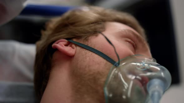 Man of Coronavirus Lying on Stretchers in Ambulance