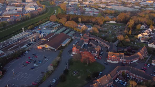 Flyover tilt up during golden hour in Alphington, Exeter, UK.