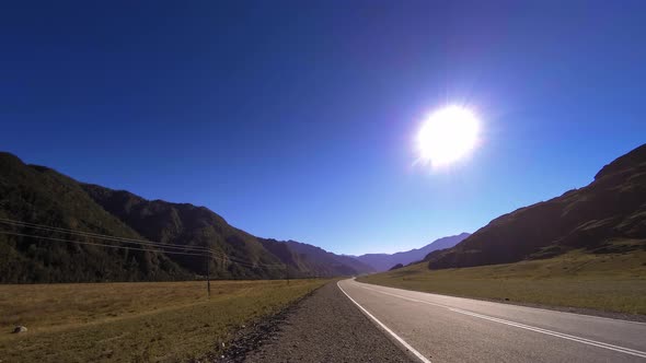 Mountain Road Timelapse at the Summer or Autumn Sunset Sunrise Time. Wild Nature and Rural Field.