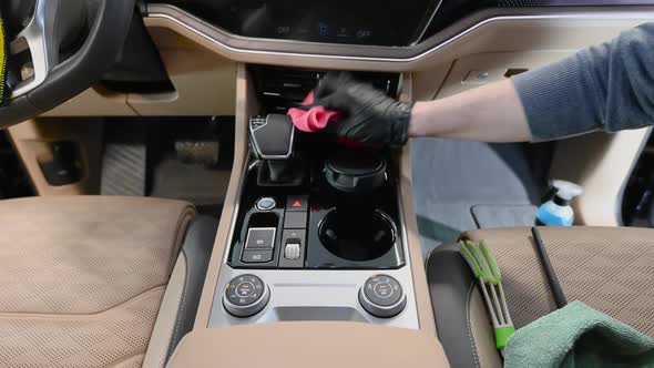 The Man Cleans the Car From the Dust Using a Damp Cloth