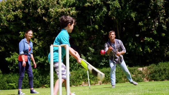 Happy family playing cricket