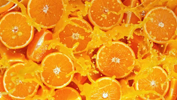 Super Slow Motion Shot of Fresh Orange Juice Splashing Through Orange Slices at 1000Fps