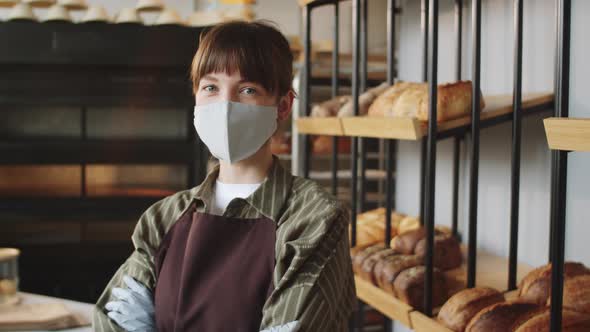 Portrait of Female Worker in Mask and Gloves in Bakery