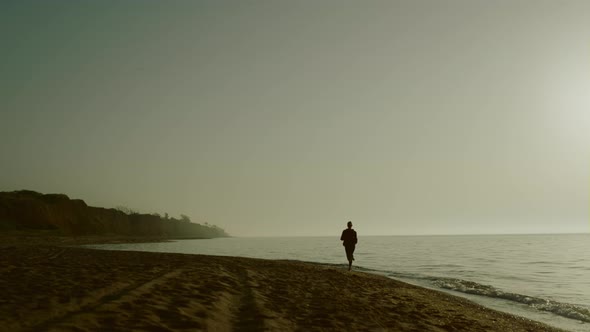 Silhouette Jogger Woman Training on Sandy Beach