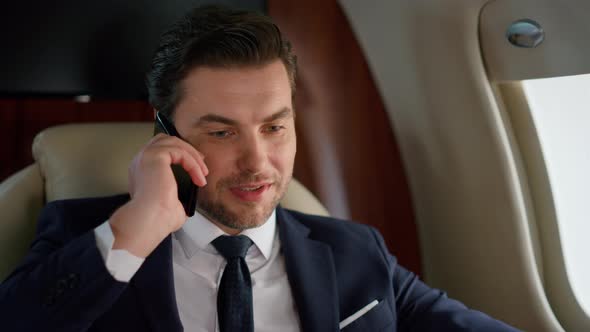 Portrait Successful Businessman Calling Partner on Corporate Airplane Trip