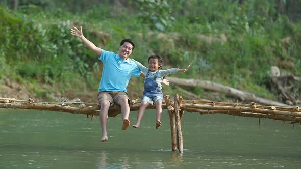 Father With His Daughter Happy On Wooden Bridge