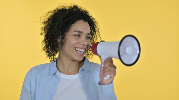 Portrait of Casual African Woman Making Announcement on Loudspeaker