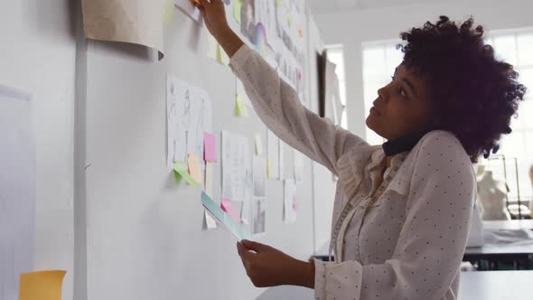 Mixed race woman working in fashion office