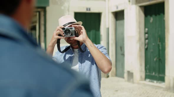 Slider Shot of Male Photographer Taking Picture of Man Outdoor