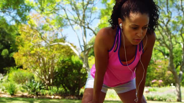 Exhausted jogger woman relaxing in the park