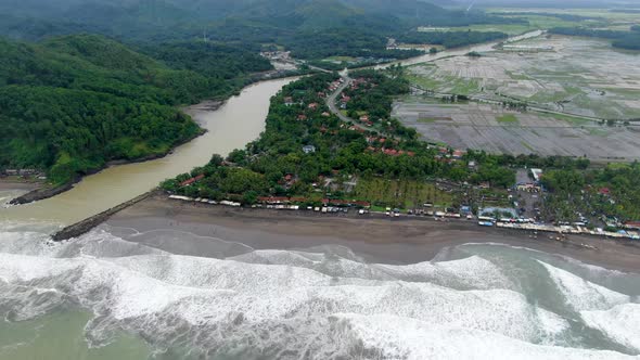 Aerial drone view of Telomoyo River and surrounding landscape near Suwuk beach in Kebumen, Indonesia