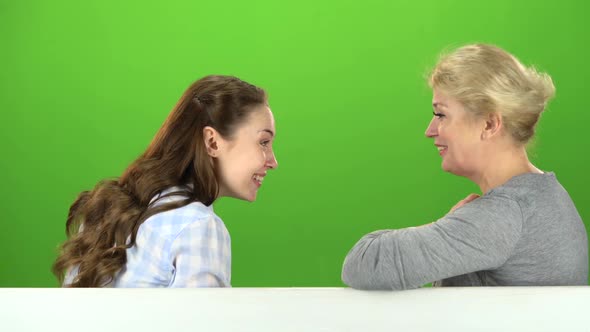 Mom and Daughter Talking on Talking on Various Topics. Green Screen. Side View