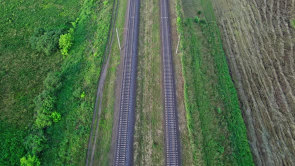 Drone Shot Showing Railroad Tracks Among Fields