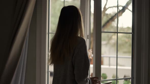 Woman Opening Curtains in Hotel Room Going Out on the Balcony Slow Motion