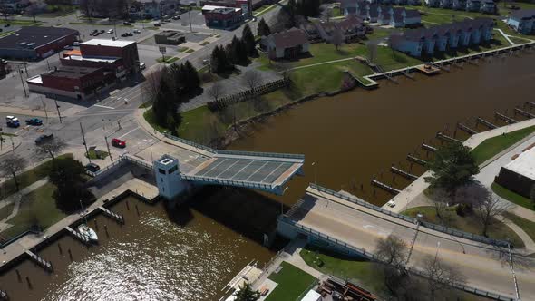 Drawbridge opening over the Black river in Port Huron, Michigan with drone videoing forward and down