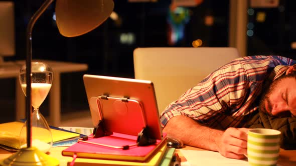 Business executive lying on his desk