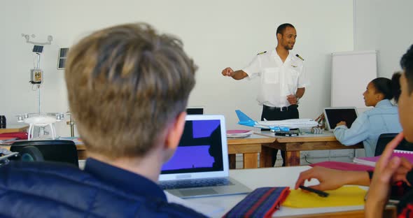 Pilot giving training about model aeroplane to kids