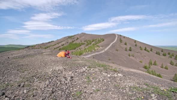 Female Hiker Preparing Campsite in Mountains