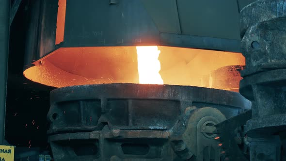 Molten Steel is Pouring Into an Industrial Barrel