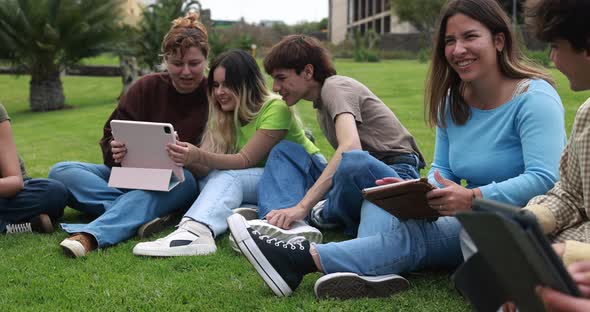 Young friends studying together outdoor sitting in university park