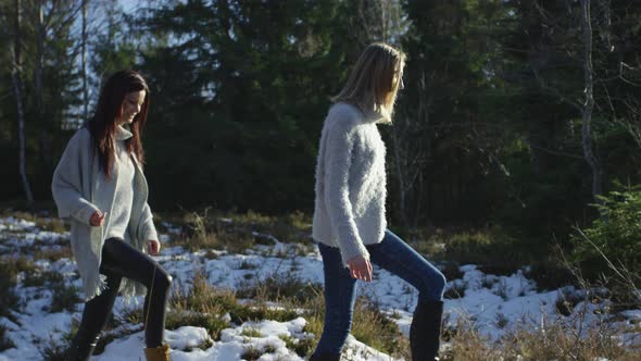 Young women walking in the forest alt