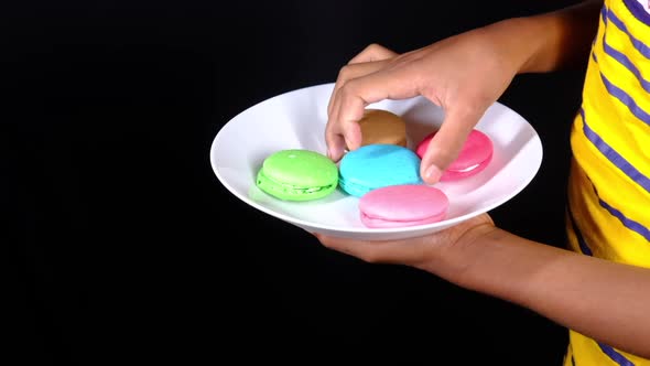 Slow Motion of Hand Pick Macaroon From a Plate