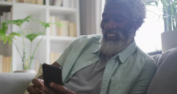 Video of african american senior man using smartphone