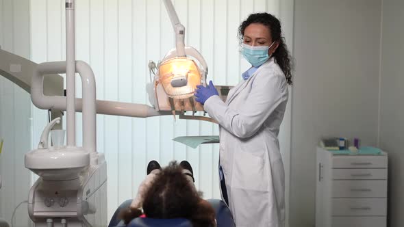 Masked Dentist Preparing Equipment for Examination