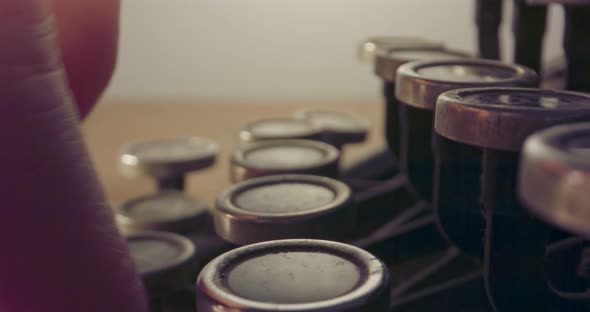 Special macro dolly shot hovering over old typewriter keys with male hand typing