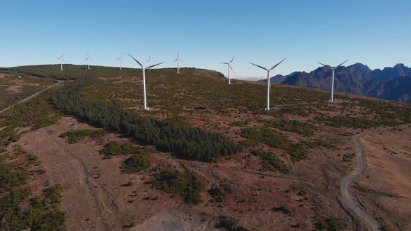 Wide panoramic shot over highland field wind turbine energy farm, Madeira Island