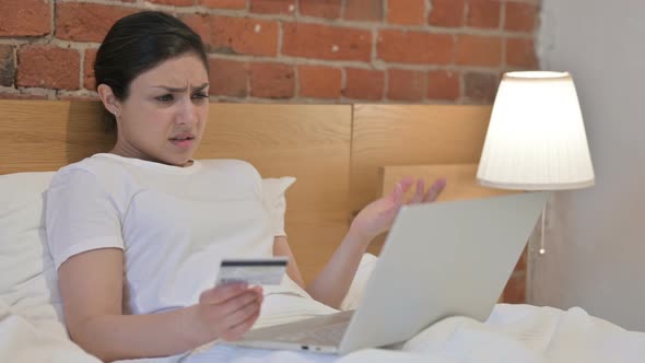 Young Indian Woman with Unsuccessful Online Payment on Laptop in Bed