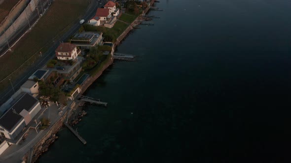 Aerial of lakeside houses, revealing beautiful large lake