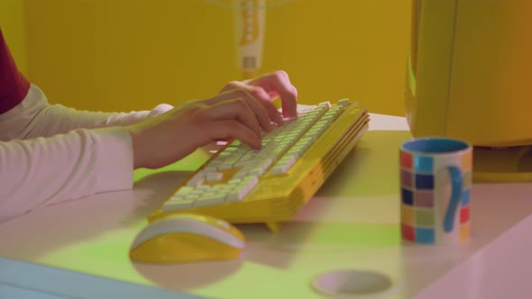 Male Hands Typing On Fancy Yellow Keyboard