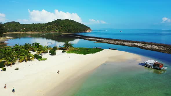 Aerial texture of exotic coastline beach time by blue green water and white sand background of a day