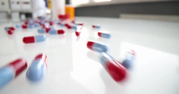 Scattered Medical Pills From Jar on Table