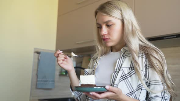 Delicious Cake on a Saucer Spoon Breaks Off a Piece