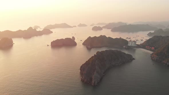 Aerial: sunset clear sky at Cat Ba island and beach with new tourist resort, Halong bay Vietnam