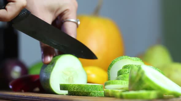 Female Chef Cuts a Cucumber