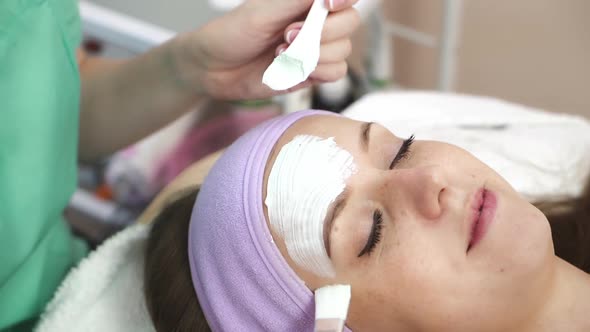 Woman with cosmetic mask. Beautiful girl with cosmetic mask on face