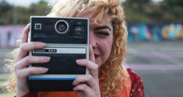 Young girl using vintage old camera outdoor