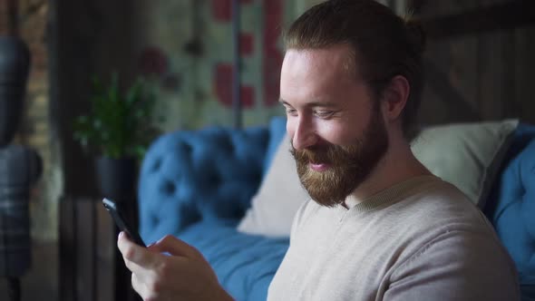 Man Giggling Laughing When Scrolling His Phone