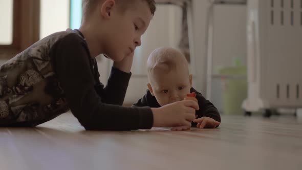 Older Brother Playing with Younger Baby Sister