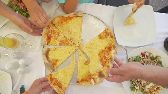 Family taking delicious cheese pizza