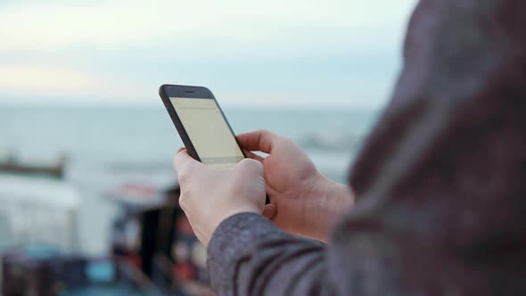 Close Up Shot of the Man's Hands He Holds Smartphone and Scans the Incoming Mail