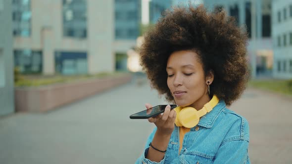 Beautiful young woman with curly hairstyle and fashionable clothes