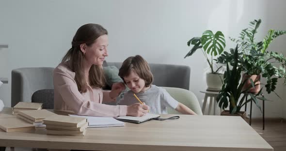 Loving Mother Tries to Teach Her Restless Active Son Who Has Difficulty Concentrating in Class