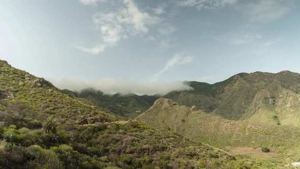 Beautiful clouds rolling over mountain range in northern Tenerife island, time lapse shot