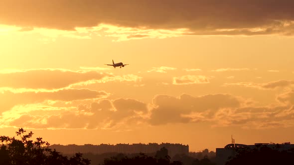 Airplane is Landing at Sunset