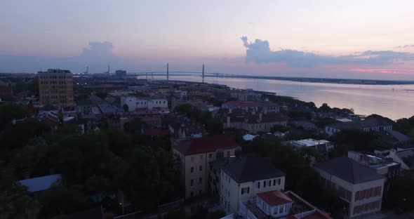 Charleston SC rooftops and harbor at sunrise